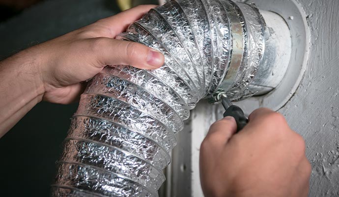 a professional repairing a duct