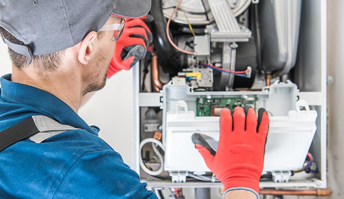 a professional performing maintenance on boiler parts