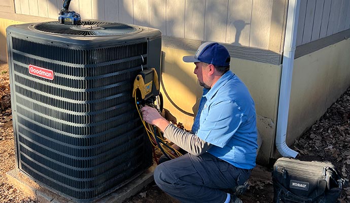 Expert inspecting heating system using equipment